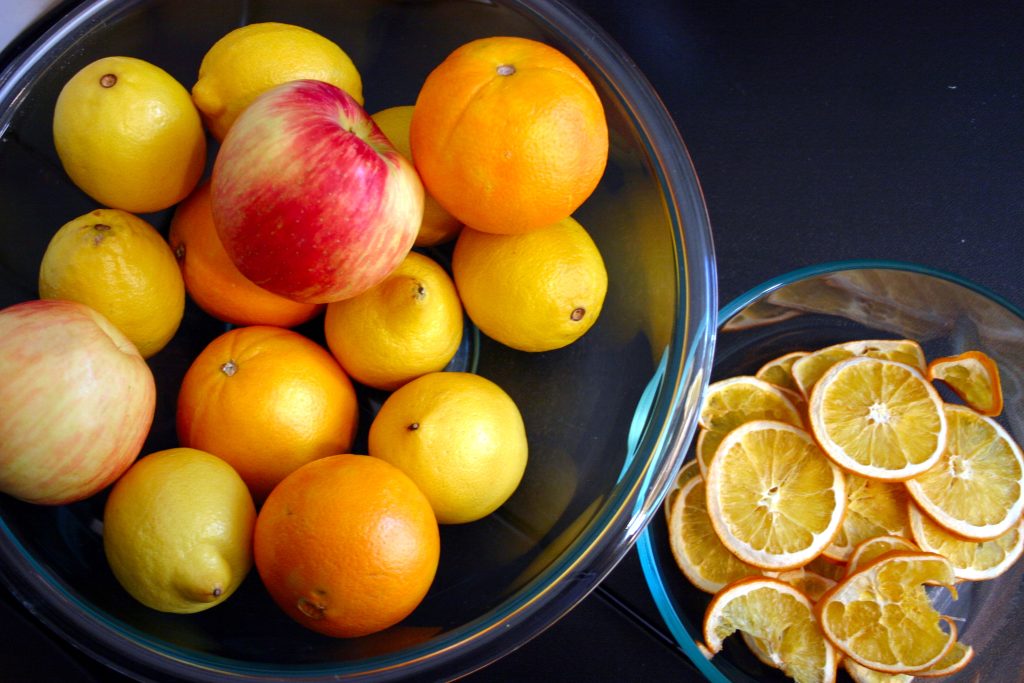 a bowl of various fruits next to a bowl of dehydrated fruit