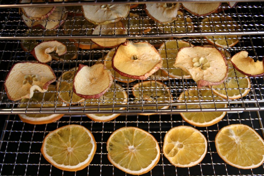 apples and orange on a dehydrator rack