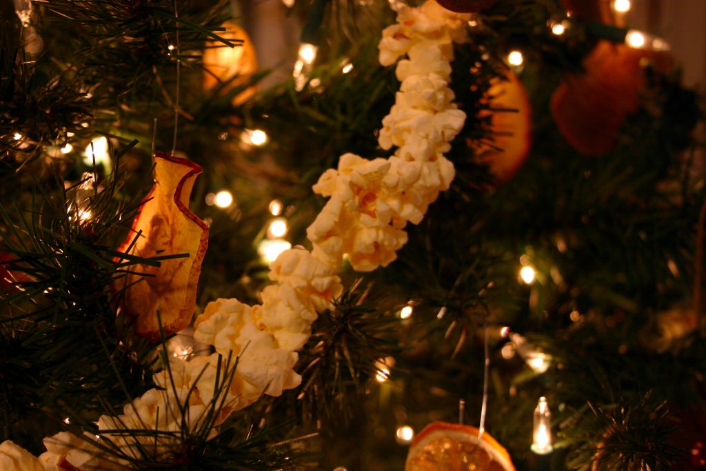 popcorn garland on a Christmas tree with apple and orange slices