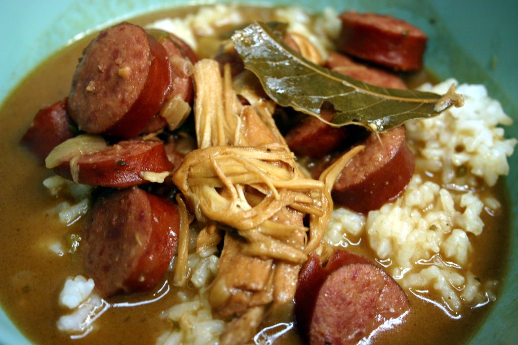 chicken, sausage, and bay leaves in a bowl of gumbo