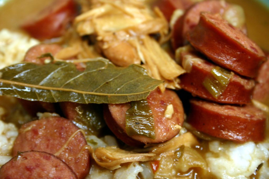 chicken, sausage, bay leaves, and rice in a gumbo
