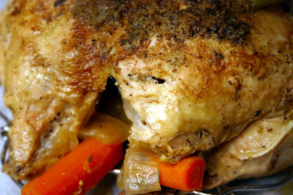 Cooked whole chicken with carrots