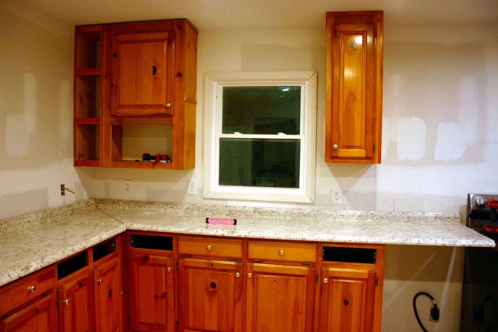 assembling kitchen cabinets on either side of a window