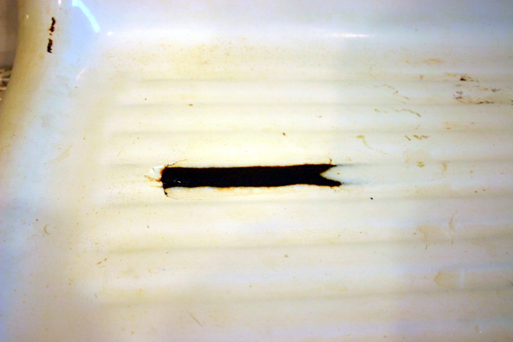 A chip in an old cast iron sink