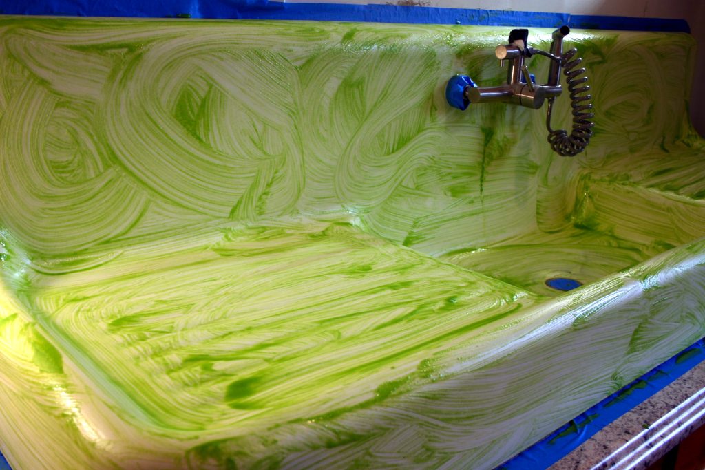 A chemical etcher applied to an old cast iron sink