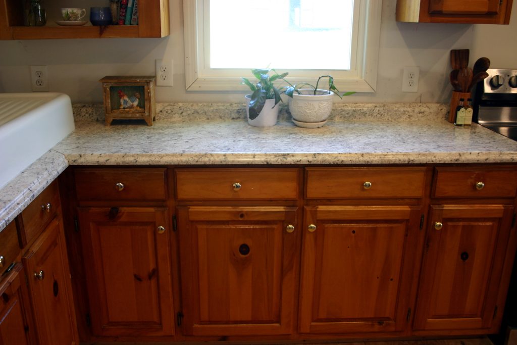lower cabinets and countertops with decorations on them