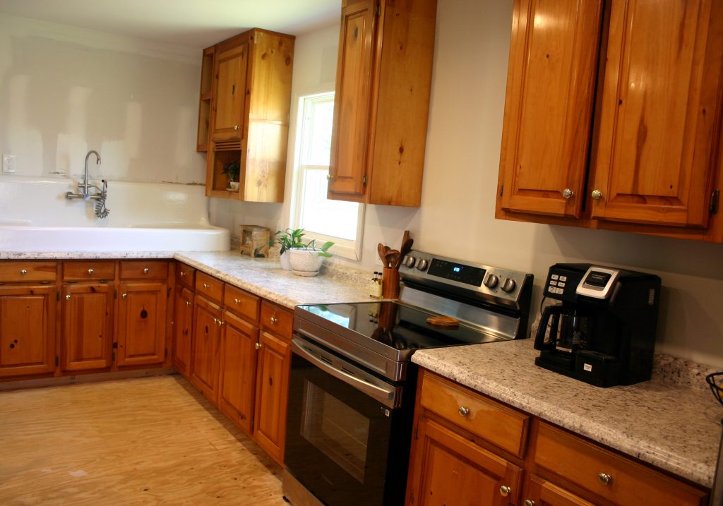 kitchen design with cabinets, oven, and antique sink