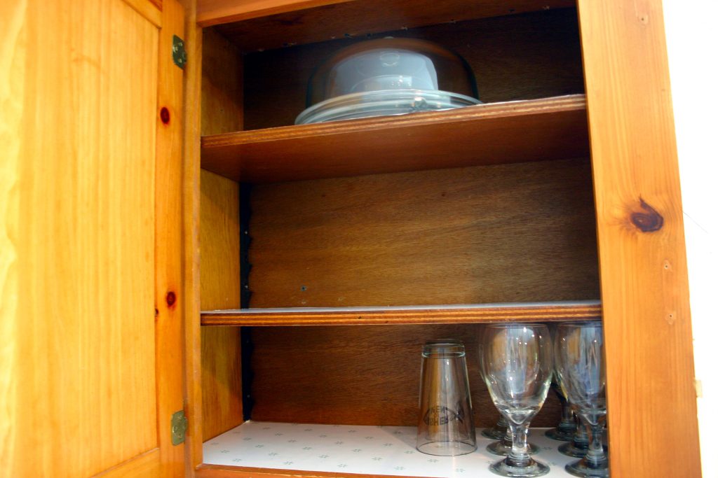 shelves with glassware in a kitchen cabinet