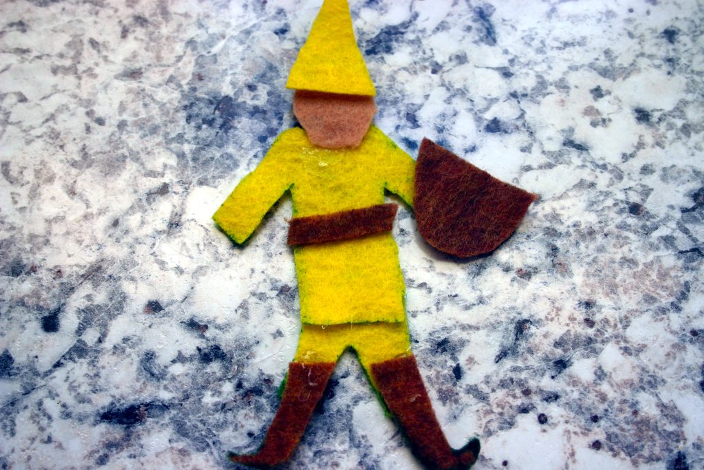 a small yellow felt figure