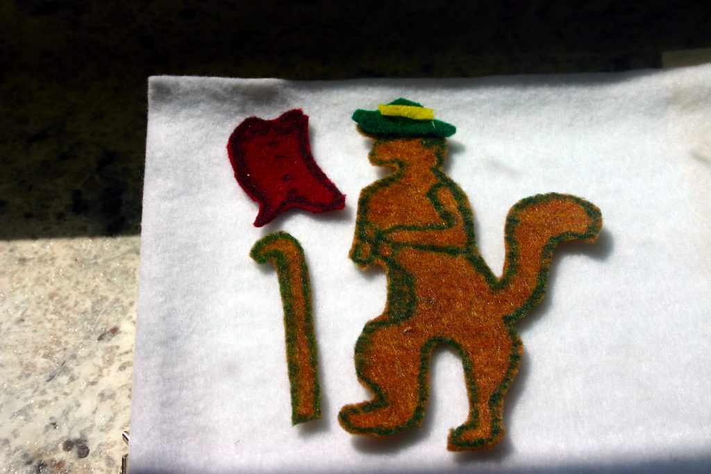 felt figure with his outfit on a storyboard