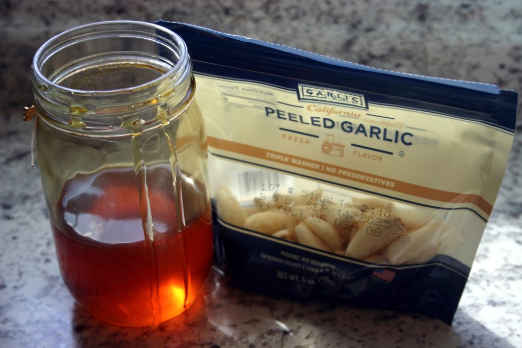 a jar of honey and a bag of garlic